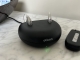 2 oticon real hearing aids sitting in the standard charger with a green light on