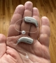 2 oticon real hearing aids in palm of hand