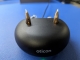 two real hearing aids being charged with the orange indicator light on