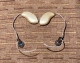 two Genesis ai mRIC 24 hearing aids in beige laying flat on a table side by side