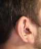 close up of lumity life hearing aids sitting behind mans ear