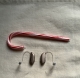 two brown nexia 7 rechargeable hearing aids next to a candy cane to show scale