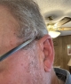 left champagne Lumity Life 90 hearing aid on the ear