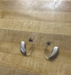 a pair of champagne lumity life 90 hearing aids side by side on a table