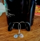 2 nexia hearing aids leaning against a mug