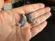 Pair of Oticon Intent 1 hearing aids in color steel grey in hand