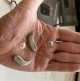 Oticon Intent 1 hearing aid and Real CROS transmitter in hand