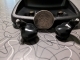 Pair of Starkey Genesis AI ITC 24 hearing aids next to a quarter for scale