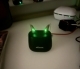 pair of chroma beige oticon intent in charger green lights