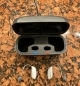 2 nexia 9 hearing aids laying next to charger