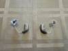 pair of oticon intent 1 with earmolds on table