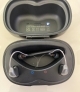 pair of starkey genesis ai graphite gray in charger