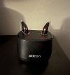 A pair of Oticon Intent MiniRITE 3 in black in charger