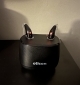 A pair of Oticon Intent MiniRITE 3 in black in charger