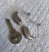 pair of oticon intent 1 next to key for scale