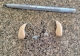 pair of sphere 90 hearing aids in sand beige on counter next to pen for scale