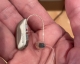 Single resound vivia 9 rechargeable hearing aid in palm of hand