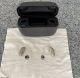 Pair of Resound vivia 9 in sand next to charger