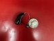 Phonak Audeo Sphere 90 in chestnut brown next to a quarter on a table