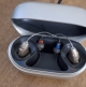 Pair of Audeo Sphere Infinio 90 in sand beige in charger