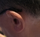 Starkey Edge AI 24 mRIC in tech black up close shot from behind on left ear