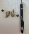 Phonak Sphere 90 in champagne next to a pen for scale shot 2 of 2