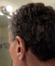 Left Phonak Audeo Sphere Infinio 90 in graphite grey on the ear