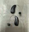 Pair of Phonak Audeo Sphere Infinio 90 hearing aids in graphite grey on counter