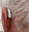 Left Phonak Audeo Sphere Infinio 90 in silver gray on left ear