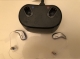 Pair of Oticon Intent 1 minirite R in silver grey next to charger