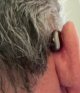 starkey edge ai 24 in chestnut on the right ear from behind