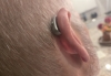 Widex moment sRIC R d 440 in silver grey close up in left ear
