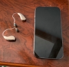 pair of phonak sphere 90 on table next to iphone