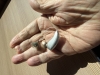 single phonak ultra sphere 90 in silver grey in palm of hand