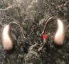 pair of phonak sphere 90 in champagne on countertop