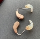 Pair of Oticon Intent 1 in honey beige with custom ear molds