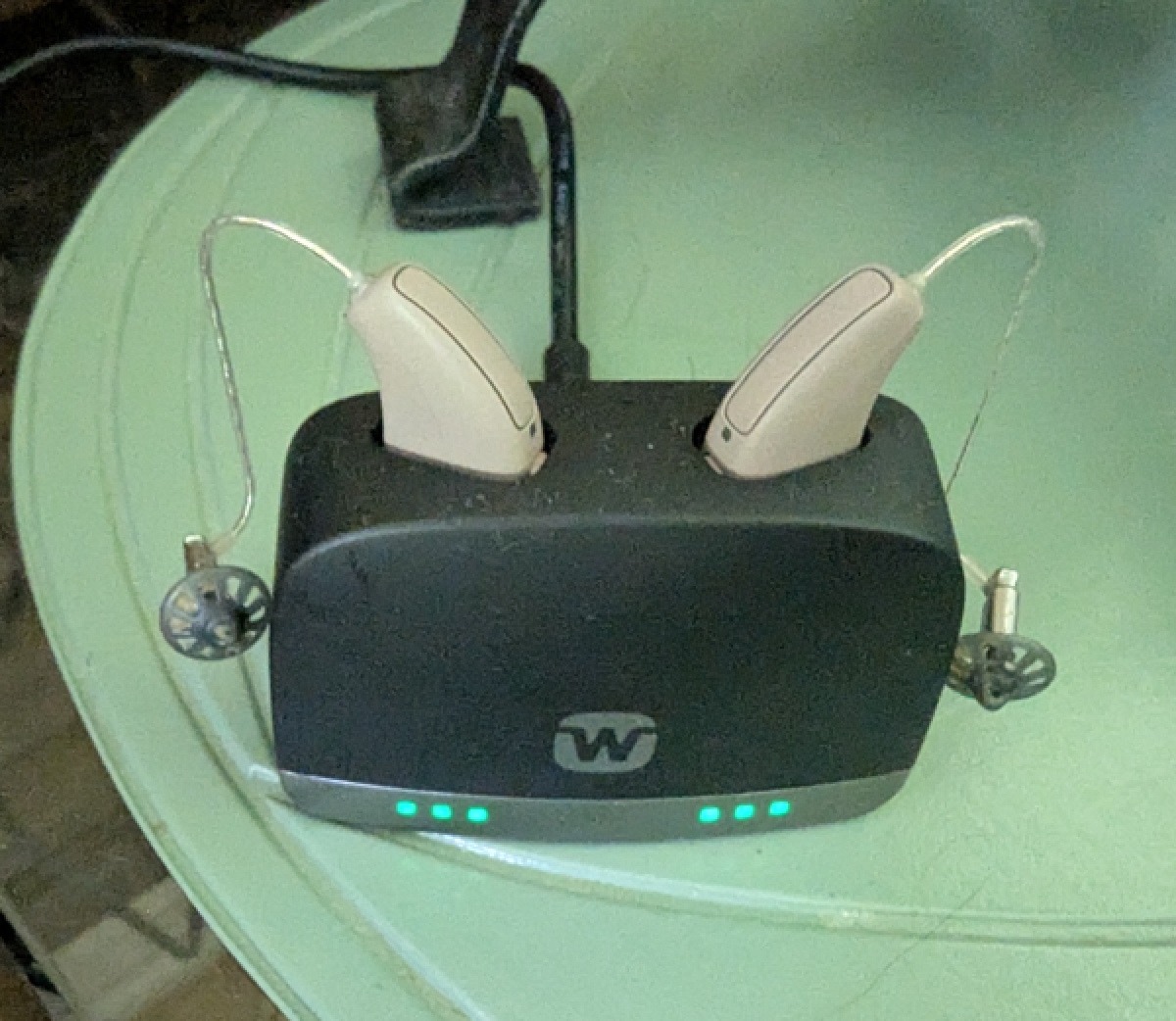 Widex Allure 440 hearing aids in autumn beige in charger