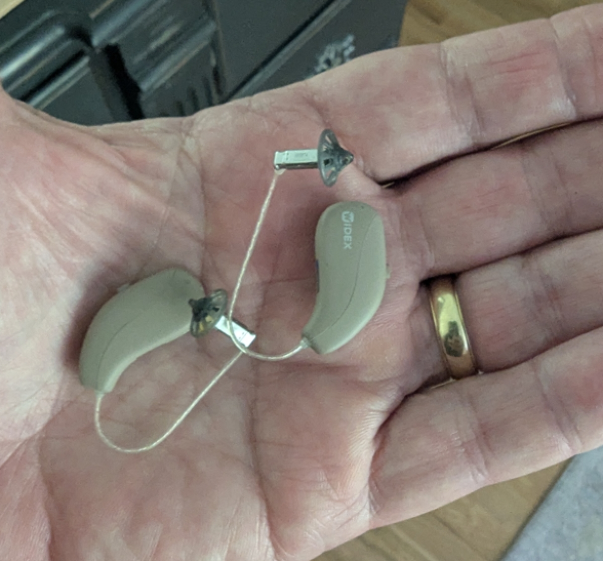 Widex Allure 440 hearing aids in autumn beige in hand