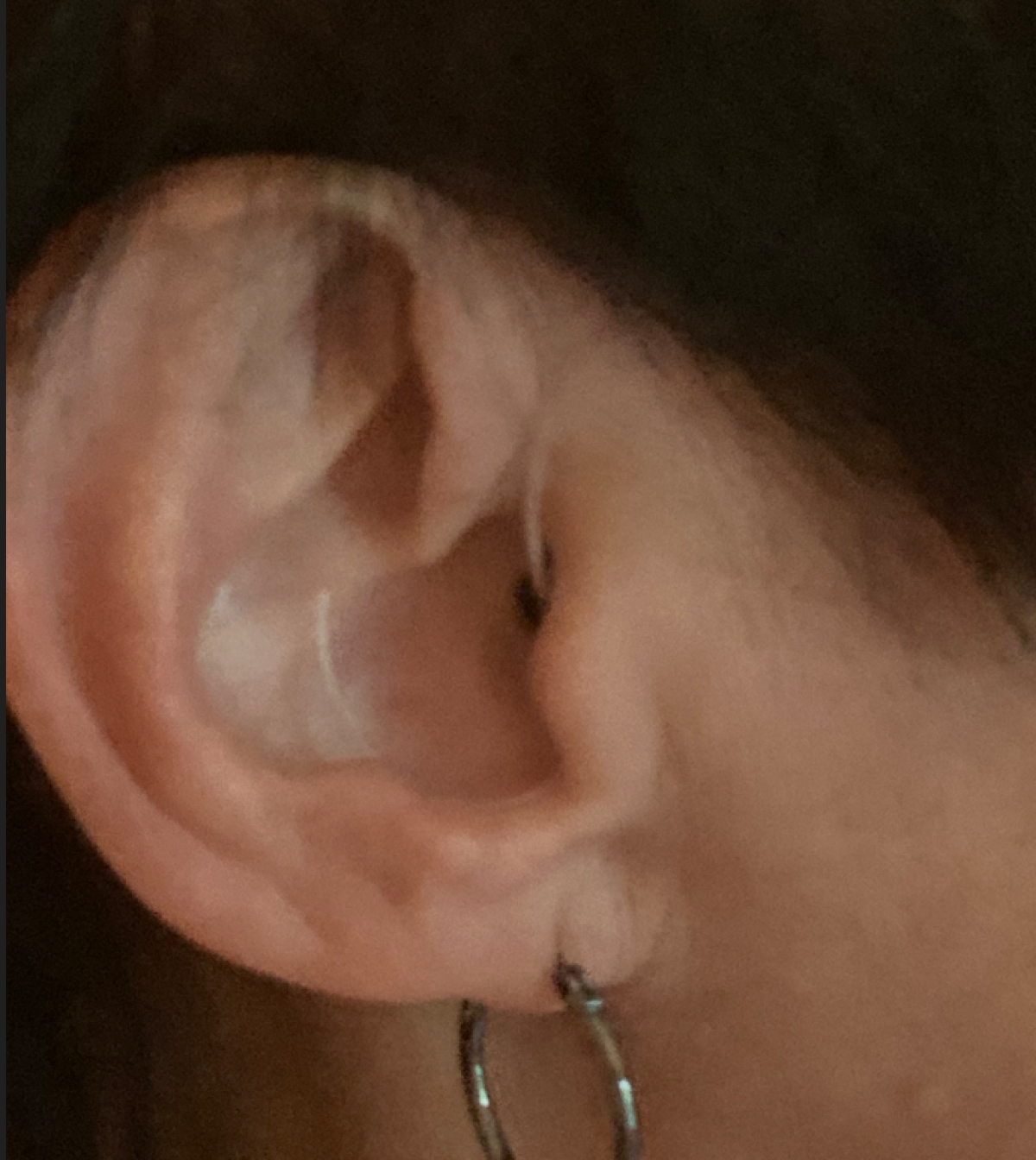 Beige starkey omega ai 24 mric behind right ear close up side shot