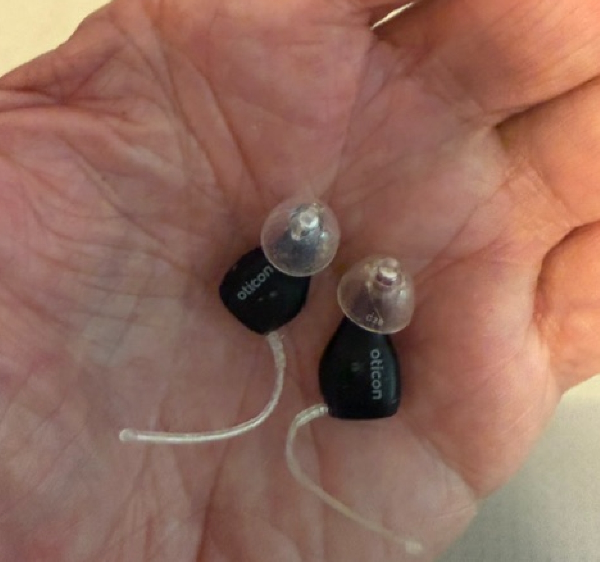 pair of oticon zeal in palm of hand