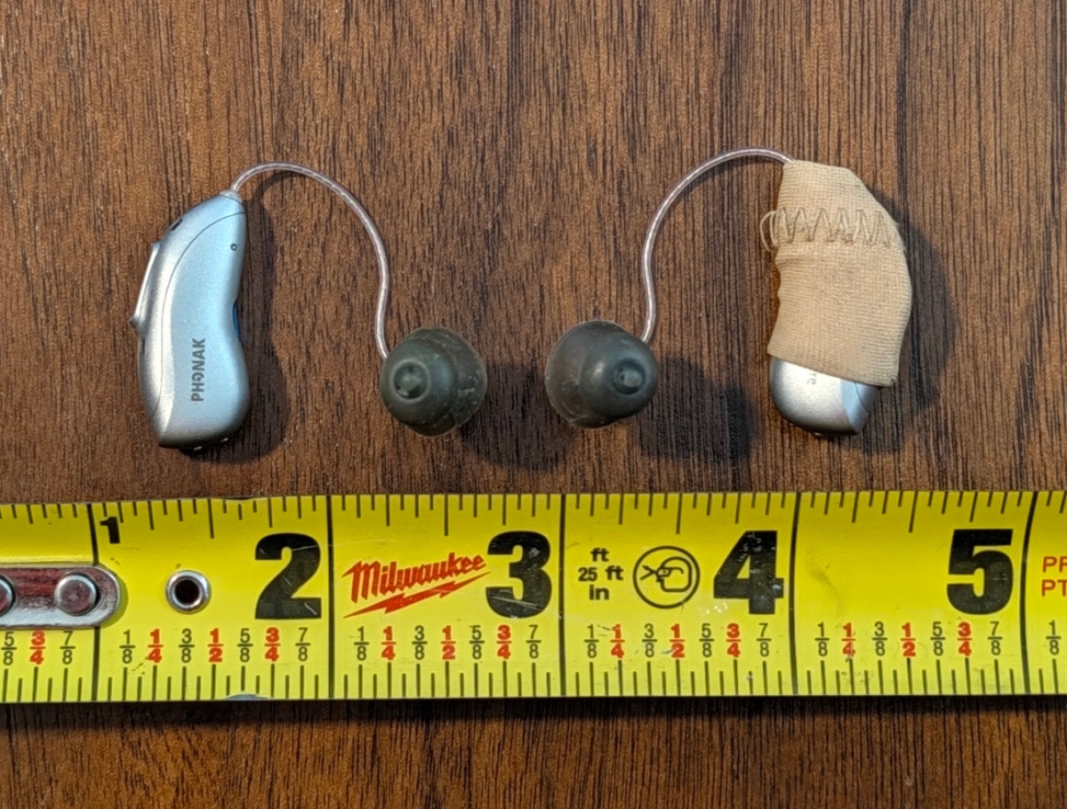 Phonak Audeo EON Sphere 90 in color silver grey laying on table next to ruler