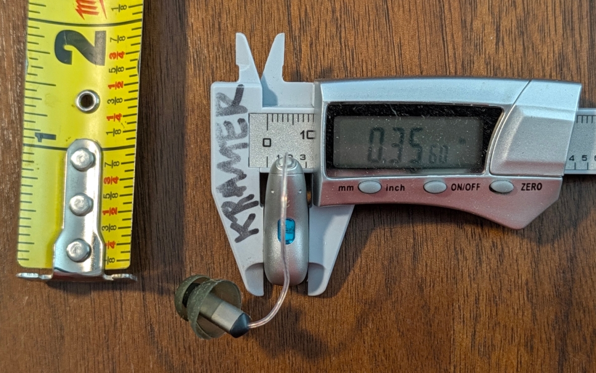 Phonak Audeo EON Sphere 90 in color silver grey next to mm measurement device