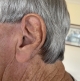 Lumity hearing aid sitting discreetly behind gentleman’s ear