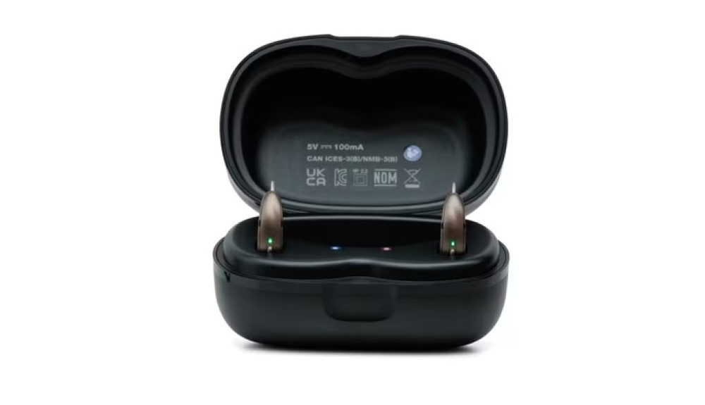 Pair of Omega AI+ mRIC R hearing aids in charger